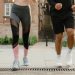 Two adults jogging outdoors, promoting health and fitness in an urban setting.